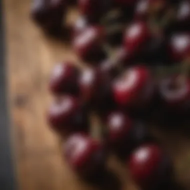 Close-up of dark cherries on a wooden surface