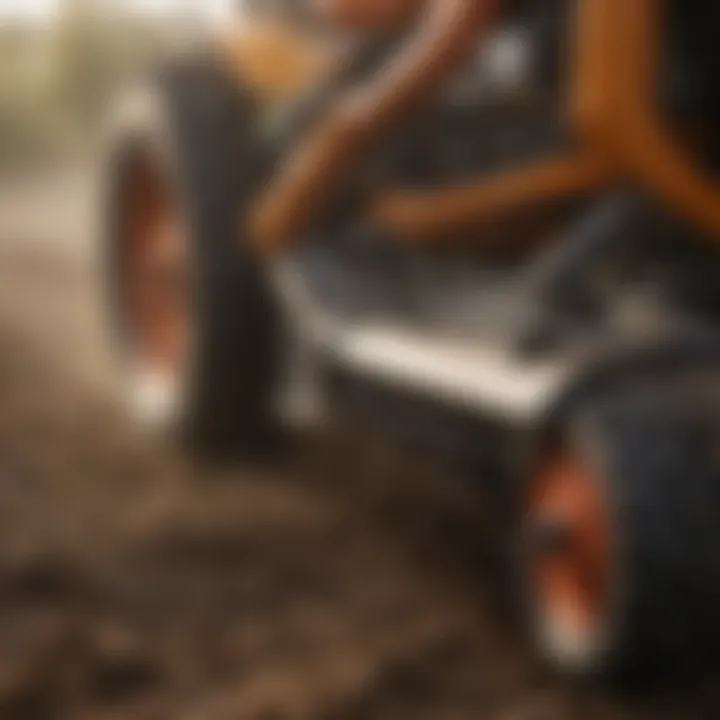Close-up of the tilling mechanism of a zero turn tiller demonstrating soil interaction